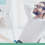 Man relaxing and smiling in office