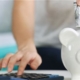 Woman placing money in piggybank